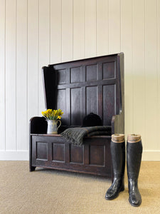 An Antique English Oak Settle with Seat Storage