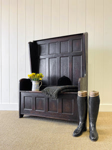 An Antique English Oak Settle with Seat Storage