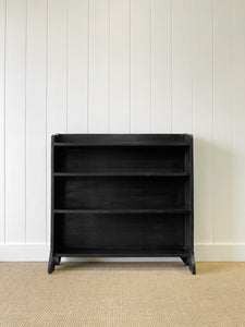 An English Ebonized Waterfall Bookcase