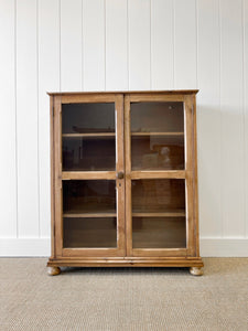 A 19th Century English Pine Glazed Bookcase on Bun Feet