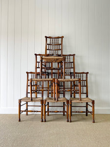 A Vintage Set of 6 English Oak Spindle Back Chairs with Rush Seats