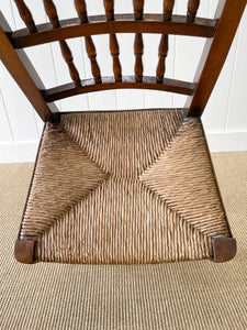 A Vintage Set of 6 English Oak Spindle Back Chairs with Rush Seats