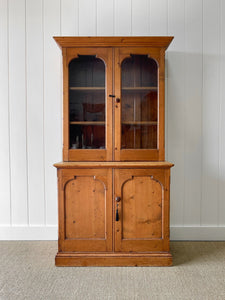A 19th Century English Pine Bookcase with Arched Doors