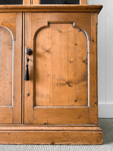 A 19th Century English Pine Bookcase with Arched Doors
