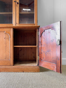 A 19th Century English Pine Bookcase with Arched Doors