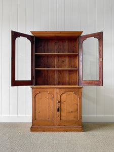 A 19th Century English Pine Bookcase with Arched Doors