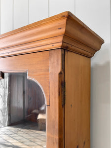 A 19th Century English Pine Bookcase with Arched Doors