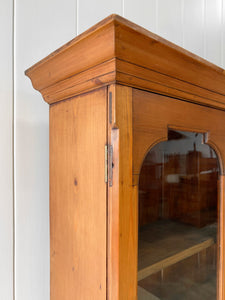 A 19th Century English Pine Bookcase with Arched Doors