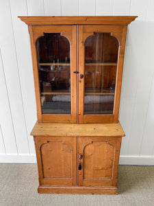 A 19th Century English Pine Bookcase with Arched Doors