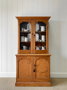 A 19th Century English Pine Bookcase with Arched Doors