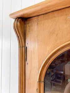A 19th Century English Pine Bookcase with Arched Doors