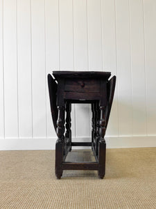 An Antique English Country Oak Drop Leaf Gate Leg Table