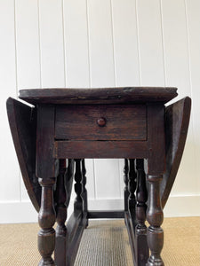 An Antique English Country Oak Drop Leaf Gate Leg Table