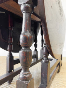 An Antique English Country Oak Drop Leaf Gate Leg Table