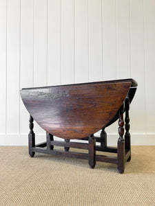 An Antique English Country Oak Drop Leaf Gate Leg Table