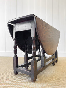 An Antique English Country Oak Drop Leaf Gate Leg Table