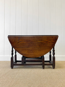 An Antique English Country Oak Drop Leaf Gate Leg Table
