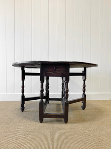 An Antique English Country Oak Drop Leaf Gate Leg Table