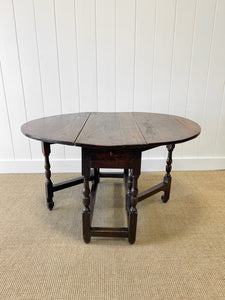 An Antique English Country Oak Drop Leaf Gate Leg Table