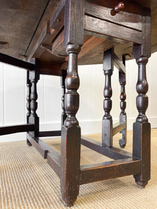 An Antique English Country Oak Drop Leaf Gate Leg Table