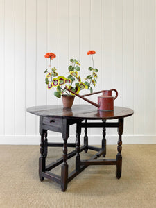 An Antique English Country Oak Drop Leaf Gate Leg Table