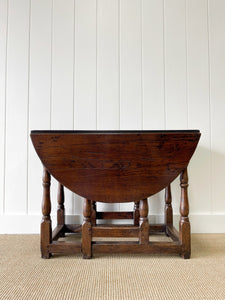 An Antique English Country Oak Drop Leaf Gate Leg Table