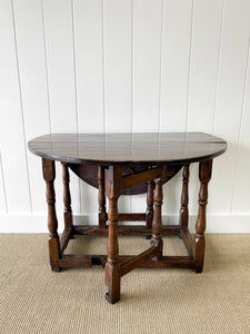 An Antique English Country Oak Drop Leaf Gate Leg Table