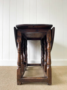 An Antique English Country Oak Drop Leaf Gate Leg Table