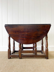 An Antique English Country Oak Drop Leaf Gate Leg Table