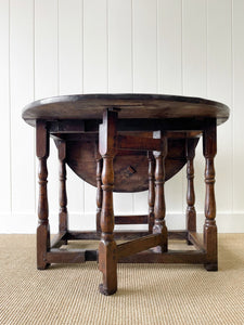 An Antique English Country Oak Drop Leaf Gate Leg Table