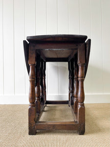 An Antique English Country Oak Drop Leaf Gate Leg Table