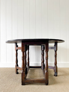 An Antique English Country Oak Drop Leaf Gate Leg Table