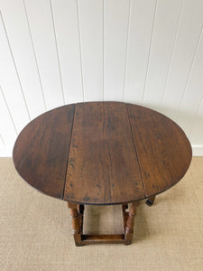 An Antique English Country Oak Drop Leaf Gate Leg Table