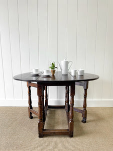 An Antique English Country Oak Drop Leaf Gate Leg Table