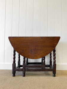 An Antique English Country Oak Drop Leaf Gate Leg Table