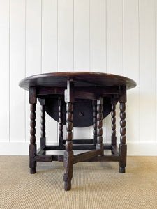 An Antique English Country Oak Drop Leaf Gate Leg Table