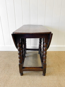 An Antique English Country Oak Drop Leaf Gate Leg Table