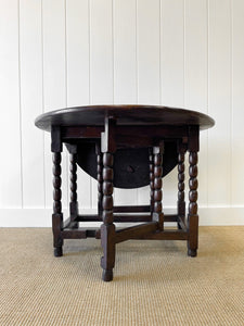 An Antique English Country Oak Drop Leaf Gate Leg Table