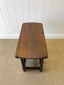 An Antique English Country Oak Drop Leaf Gate Leg Table