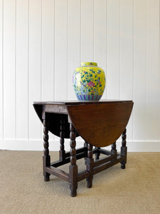 An Antique English Country Oak Drop Leaf Gate Leg Table
