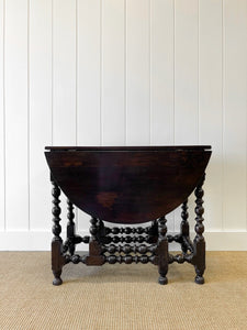 An Antique English Country Oak Drop Leaf Gate Leg Table
