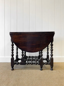 An Antique English Country Oak Drop Leaf Gate Leg Table