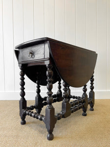 An Antique English Country Oak Drop Leaf Gate Leg Table