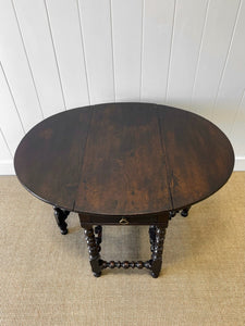 An Antique English Country Oak Drop Leaf Gate Leg Table